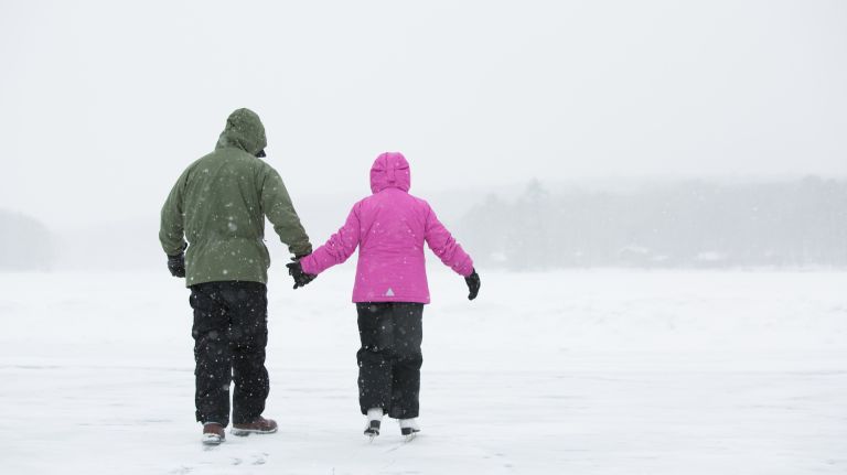 Winter activities at Woodloch in the Pocono Mountains include ice skating on a lake.