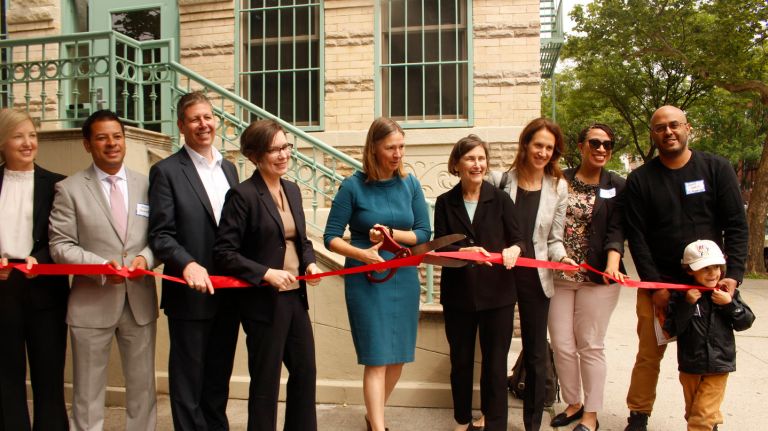 Officials from the city department of Housing Preservation and Development, members of New Destiny Housing and other investors participate in a commemorative ribbon-cutting ceremony to celebrate the completion of a $9.4 million preservation project for a set of four affordable housing buildings in Bedford-Stuyvesant.