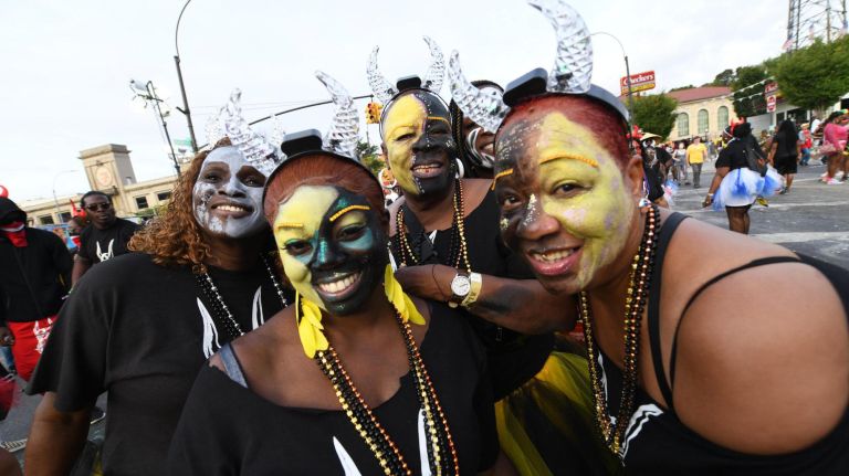 Women in face paint enjoy the&nbsp;J'Ouvert festival on Empire Boulevard in Crown Heights on Monday.