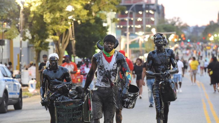 J'Ouvert festival participants gather on Empire Boulevard in Crown Heights for the annual celebration Monday.