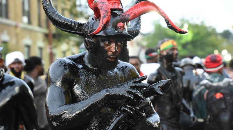 A man takes part in the annual J'Ouvert festival Monday on Empire Boulevard in Crown Heights.