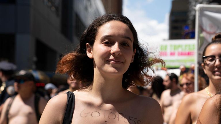 One marcher advertises the Go Topless website front and center.