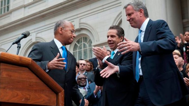 Now a clear two-way fight for NYC mayor 1 Bill Thompson, is applauded by Cuomo, center, and hugged Bill de Blasio. (Charles Eckert)