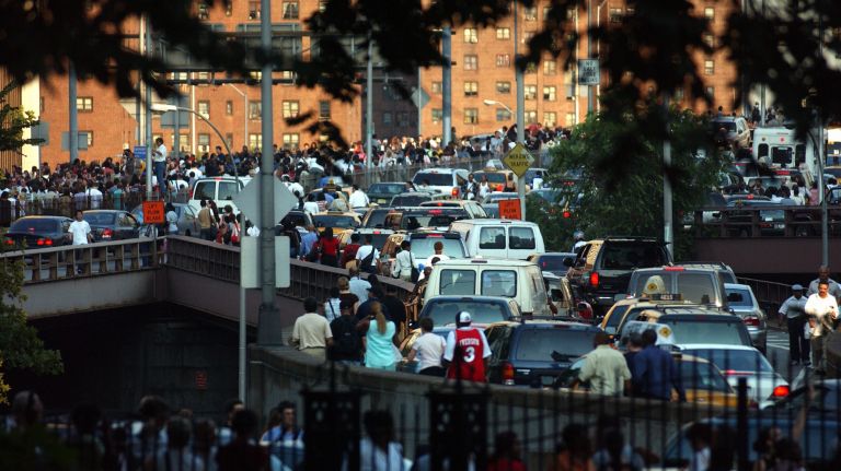 Northeast blackout 2003: Photos of NYC 9 New Yorkers cross the Brooklyn Bridge after a massive blackout throughout the Northeast stalled trains and forced commuters onto the streets.