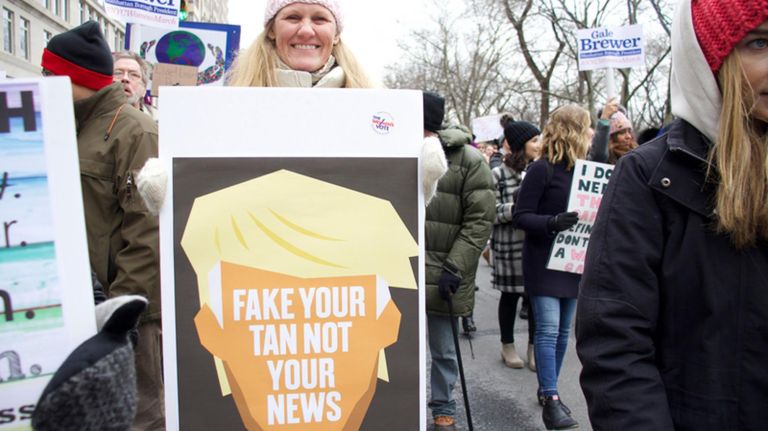 Lotta Merlino shows off a sign her friend Susan Townsley made for the Women's March on NYC near Columbus Circle on Saturday.