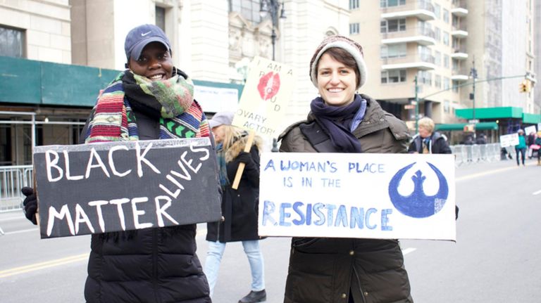 Both Kaisii Varner, left, and Claire Anderson, right, felt intersectionality was an important part of the Women's March on NYC near Columbus Circle on Saturday.