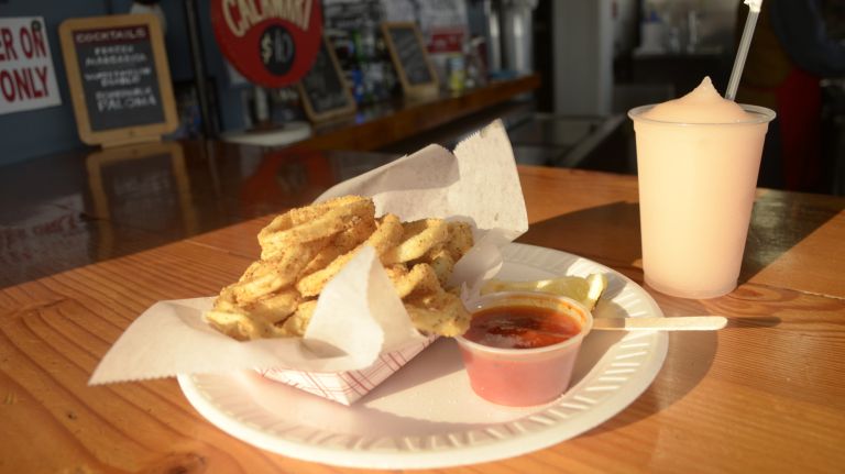 If you're not fixed on getting a Nathan's hot dog on Surf Avenue, you don't need to go far to grab a bite to eat, especially if you're in your swimsuit. Check out Paul's Daughter (1001 Riegelmann Boardwalk), which has been around since the 1950s. It has basically anything you might be craving from fried calamari, clams, lobster rolls, hot dogs, pizza, Italian sausages, even knish. Grab a local draft beer or try the 
