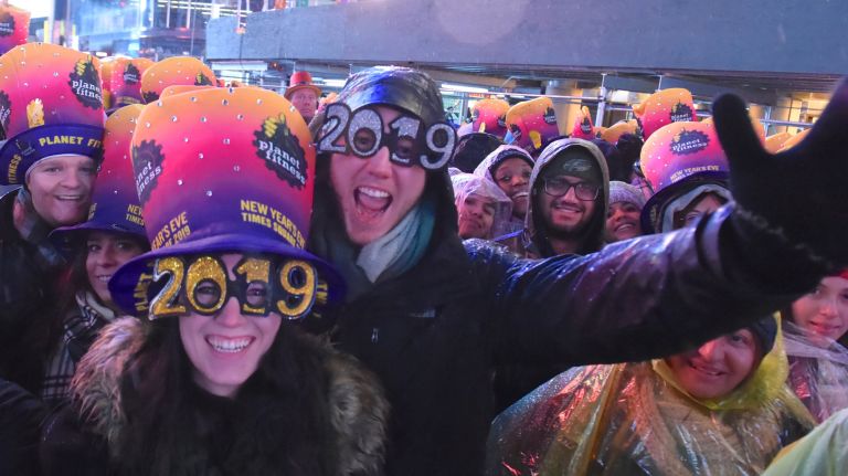 The rain didn't dampen spirits as revelers gathered in Times Square on New Year's Eve on Monday.