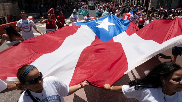 A large Puerto Rican flag is carried on 5th Avenue during the 2019 Puerto Rican Day Parade, Sunday, June 9, 2019. The parade is in its 62nd year and is celebrating the creativity and diversity of thought in Puerto Rico and across the diaspora, according to the parade organizers.