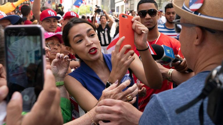 U.S. Rep. Alexandria Ocasio-Cortez takes pictures with spectators lining 5th Avenue during the 2019 Puerto Rican Day Parade, Sunday, June 9, 2019. The parade is in its 62nd year and is celebrating the creativity and diversity of thought in Puerto Rico and across the diaspora, according to the parade organizers.