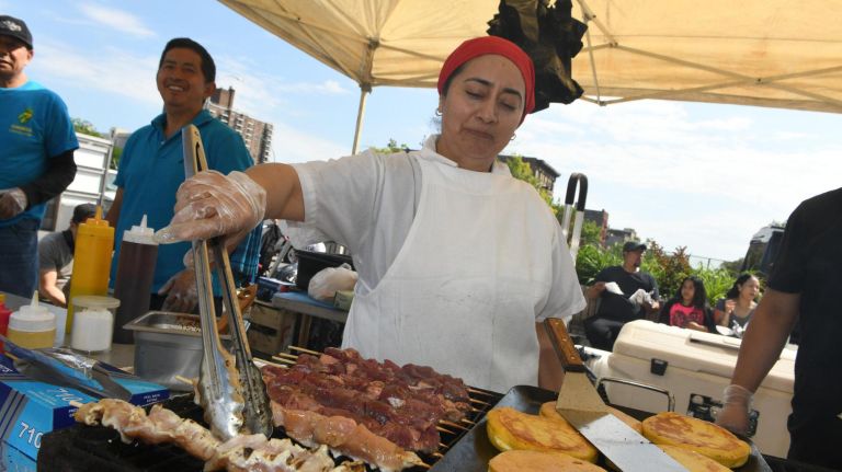 Nancy Alvarez serves up fresh food at The Bronx Night Market. The market began its second season with a bang as thousands flocked to try the variety of food and drink at the Fordham Plaza site in the Bronx.