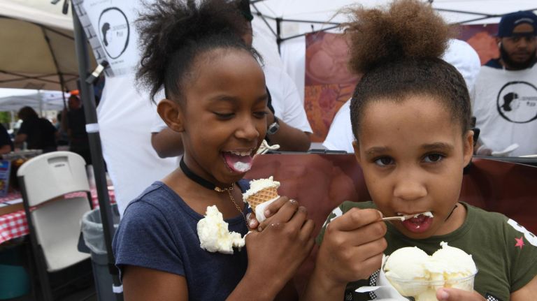 Aaliyah Laveet, 9, enjoys her ice cream for the moment with friend Keillys Sigua, 7, and then, boom, it falls off the cone at The Bronx Night Market. The market began its second season with a bang as thousands flocked to try the variety of food and drink at the Fordham Plaza site in the Bronx.