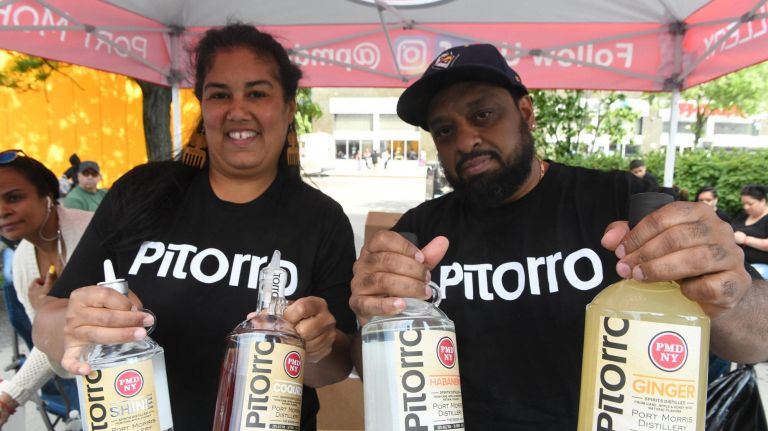 Modern day moonshiners Christine Nazario and Manny Munoz sell their Bronx brewed moonshine at The Bronx Night Market, which began its second season with a bang as thousands flocked to try the variety of food and drink at the Fordham Plaza site in the Bronx.