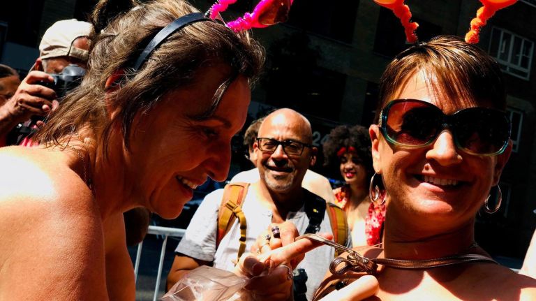 Nadia Salois of Montreal takes her shirt off before the start of the 11th annual GoTopless Day parade.