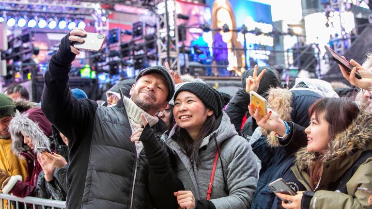 Performer Donnie Wahlberg, of the group New Kids On the Block,&nbsp;takes selfies with fans in Times Square on Dec. 31, 2018.