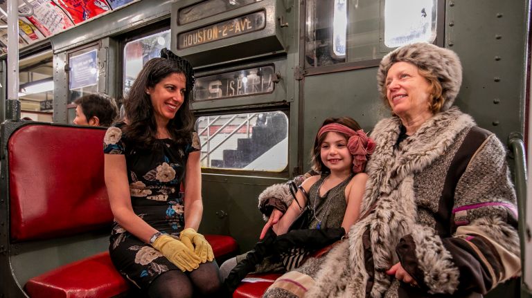 The Holiday Nostalgia Trains will roll through Manhattan every Sunday through New Year's Eve. Talia Milgrom-Elcott and her daughter Sela Milgrom-Dorfman, 8, both from of Brooklyn, and her grandmother Shira Milgrom of White Plains on the holiday vintage 1930's R1-9 train car on Sunday.