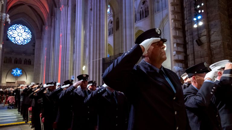 Firefighters salute as they honor eight FDNY members who have died in the past year during the 112th Annual FDNY Memorial Service for fallen firefighters at Cathedral Church of Saint John the Divine Thursday, October 10th in Morningside Heights.