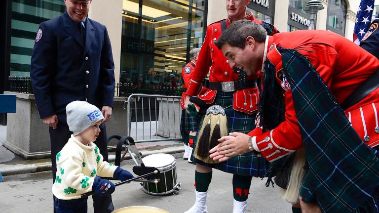Young Patrick McAvoy, his dad a member of FDNY Rescue 2, learns to play the drums for the FDNY Pipes and Drums as they wait their turn to march in the 2019 annual St. Patrick's Day parade on March 16, 2019 in New York City. The New York City St. Patrick's Day parade, dating back to 1762, is the world's largest St. Patrick's Day celebration.