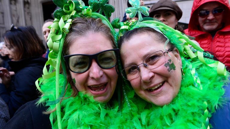 Karen Cvonick of Queens, New York and Christine Peddington of Hempstead, Long Island, watch the 2019 annual St. Patrick's Day parade on March 16, 2019 in New York City. The New York City St. Patrick's Day parade, dating back to 1762, is the world's largest St. Patrick's Day celebration.