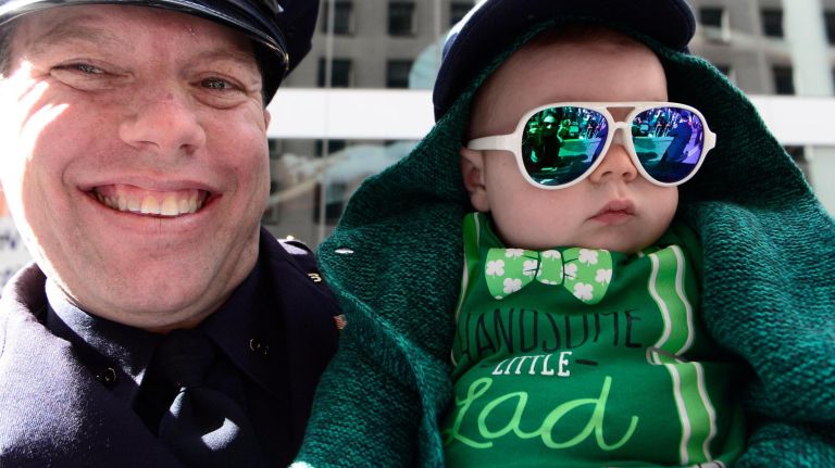 NYPD officer Joe Gallagher and his son Hudson, 6-months, are among the thousands of spectators at the St. Patrick's Day parade in Manhattan on Saturday, March 16, 2019