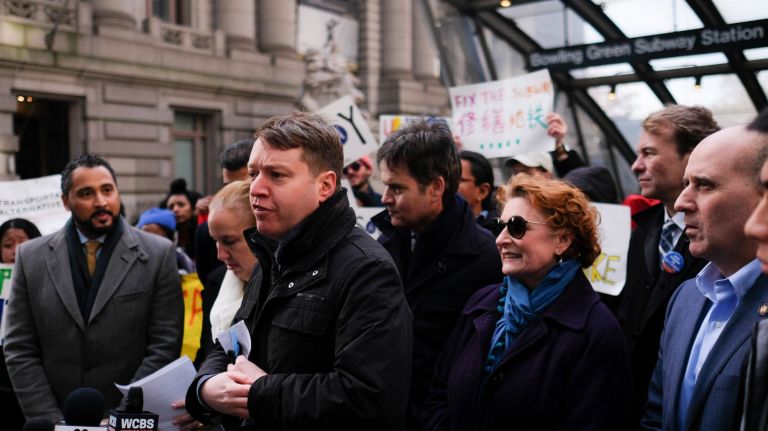 John Raskin, executive director of the Ridera Alliance, rallies with other organizations and elected officials outside of MTA headquarters on Wednesday to protest the next round of fare and toll hikes planned for early next year.