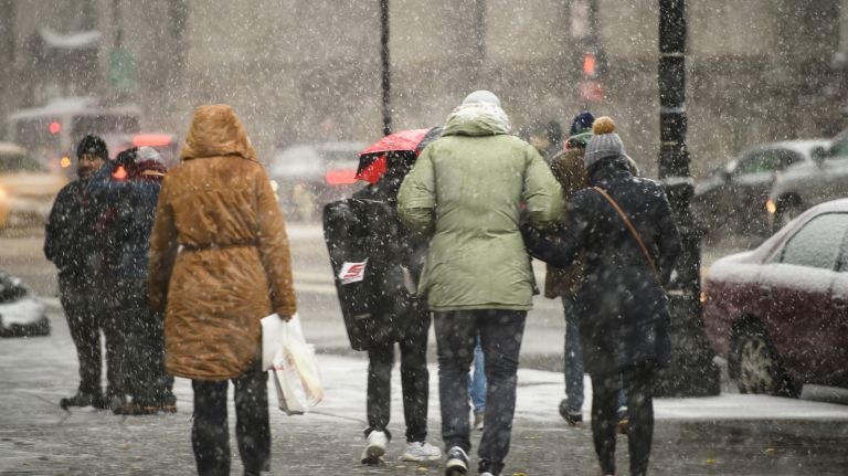 Pedestrians trudge through the falling snow on Centre Street in Manhattan on Nov. 15, 2018.