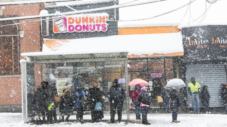 Commuters wait for the bus at East 233rd Street and White Plains Road in the Bronx on April 2, when spring brought another few inches of snow. 