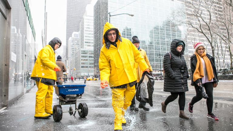 Carlos Arias and Fernando Martinez spread salt on Avenue of the Americas between 42nd and 41 Streets in Manhattan on March 21, 2018. Note: they work for QBS, Quality Building services.