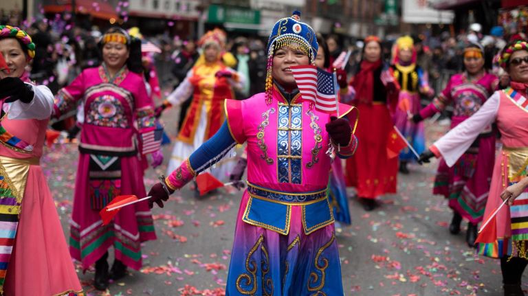 Women in traditional garb dance during the parade.&nbsp;