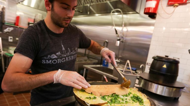 Reuben Shorser makes a 13 Spice Pork Jianbing at Jianbing at the Dekalb Market Hall.