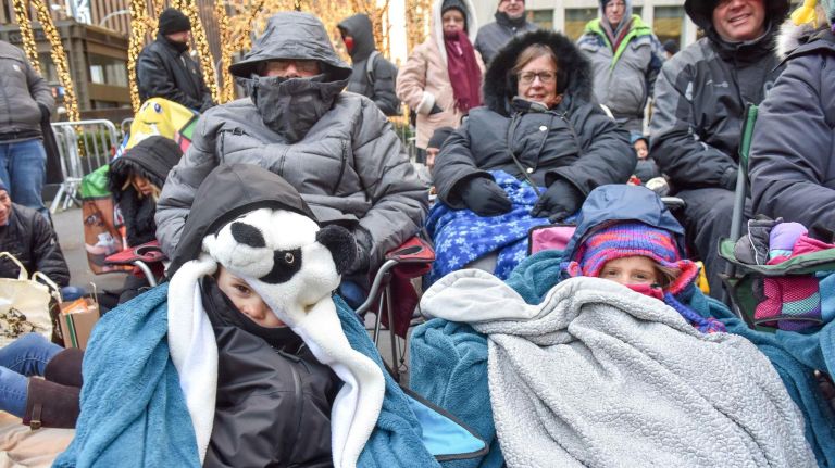 People are bundled up in many different ways, trying to keep warm before the Macy's Thanksgiving Parade on Thursday.