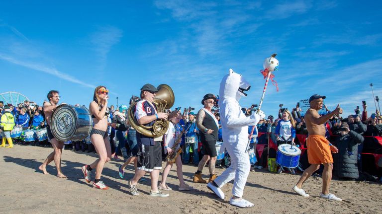 Brooklyn borough president Eric Adams leads the crowd into the water.&nbsp;