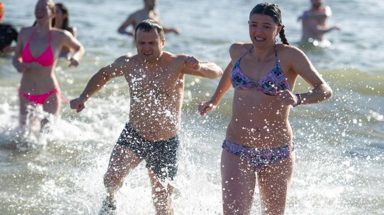 Participants run out of the surf (because really, is walking an opiton?).