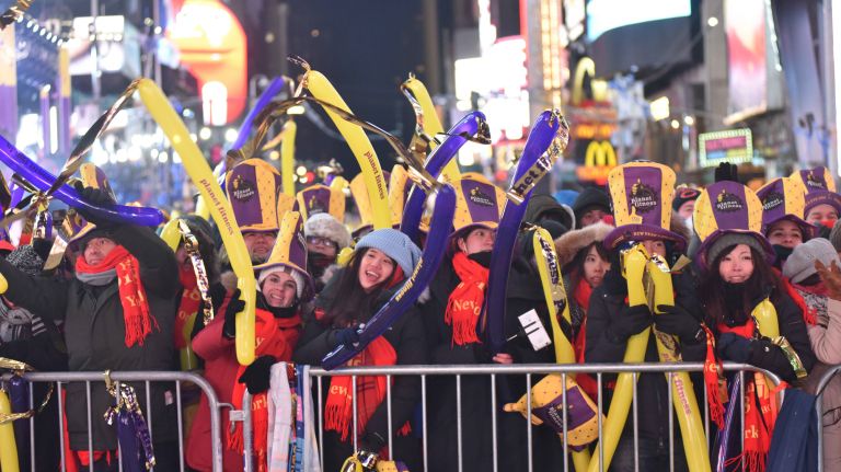 New Year's Eve revelers celebrate in a frigid Times Square in Manhattan on Sunday, Dec. 31, 2017.