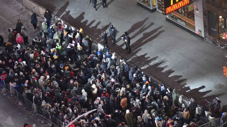 New Year's Eve revelers get ready to celebrate in a frigid Times Square on Sunday, Dec. 31, 2017.