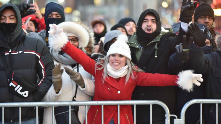 New Year's Eve revelers get ready to celebrate in a frigid Times Square on Sunday, Dec. 31, 2017.