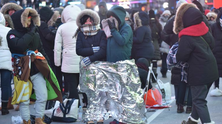 New Year's Eve revelers get ready to celebrate in a frigid Times Square on Sunday, Dec. 31, 2017.