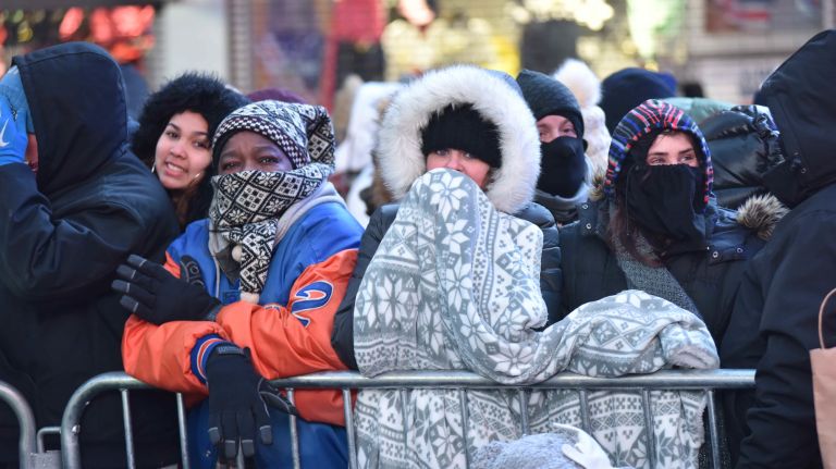New Year's Eve revelers get ready to celebrate in a frigid Times Square on Sunday, Dec. 31, 2017.