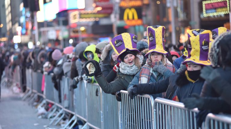 New Year's Eve revelers get ready to celebrate in a frigid Times Square on Sunday, Dec. 31, 2017.