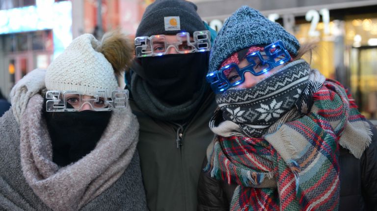 New Year's Eve revelers get ready to celebrate in a frigid Times Square on Sunday, Dec. 31, 2017.