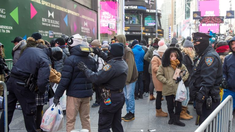 NYPD officers work at a security checkpoint in Times Square as revelers enter into one of the pens where they will wait for the festivities to commence, on New Years Eve, Sunday,Dec. 31, 2017. 