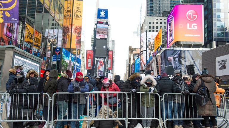 These New Year's Eve revelers were among the first to arrive in Times Square about 8 a.m., Sunday, Dec. 31, 2017, some 16 hours before the ball was set to drop, marking the end of 2017.