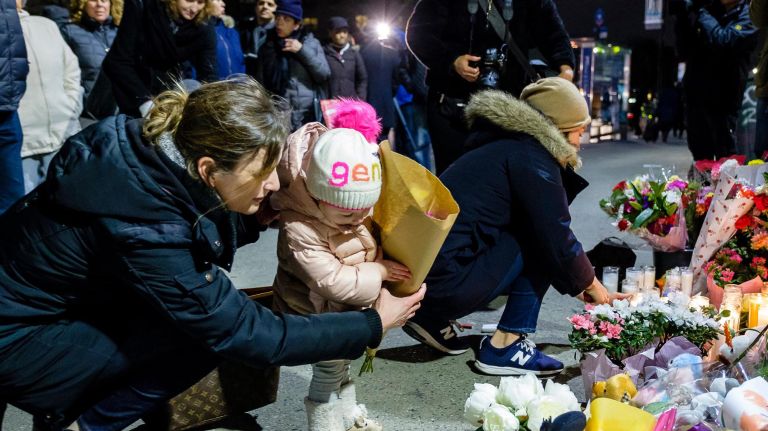 Best of 2018: Top New York City photos of the year 28 Adrienne Zdaniewski and her daughter Gray 2, place flowers in a makeshift memorial during a vigil at the corner of 5th Avenue and 9th Street in Park Slope where two children were killed in a car crash yesterday, Tuesday, March 6, 2018.