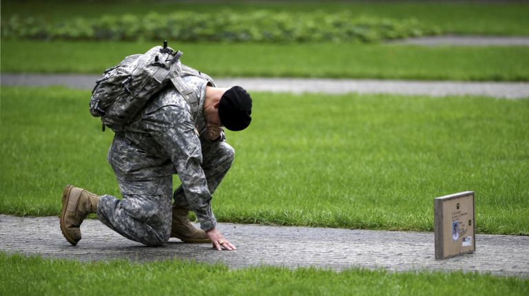 Best of 2018: Top New York City photos of the year 43 Army Reserve Sergeant Edwin Morales takes a knee for his cousin, FDNY Firefighter Ruben Correa, who died during the Sept. 11 attacks on the World Trade Center during a commemoration ceremony at Ground Zero marking the 17th anniversary on Tuesday.