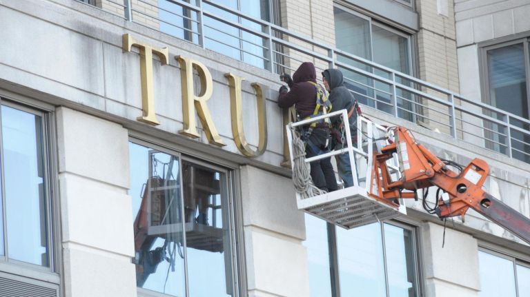 Best of 2018: Top New York City photos of the year 44 Workman shown taken down Trump Place sign on co-op apartment house at 200 Riverside Blvd in Manhattan. 10/18//2018