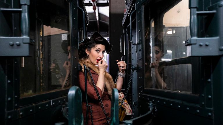 Inside the MTA nostalgia train 9 Tiffany Rae Knight of Queens stands between the cars in 1940's attire.