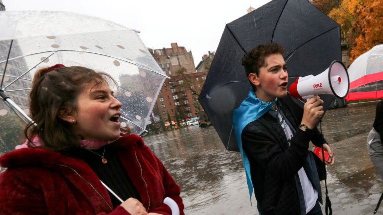 High school students Abby Gluck and Hudson Flynn try to encourage passersby to vote on Tuesday during an Election Day rally in Union Square.