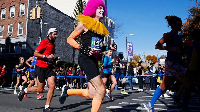 A costumed runner flies by during the marathon on Sunday.