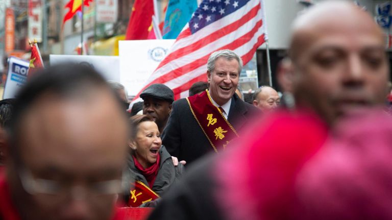 New York City Mayor Bill de Blasio marches with U.S. Rep. Nydia Velazquez and other politicians.