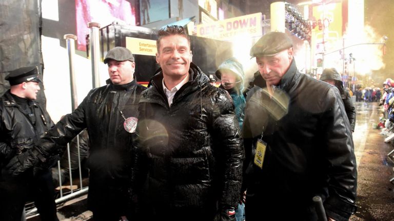 Many people attended the Times Square New Year's Eve ball drop in Times Square, many getting there early in the morning. Ryan Seacrest makes a very soggy walk through the crowd.
